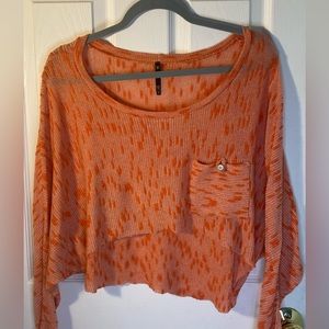 Love culture, size small, Orange and white cropped sweater with side pocket.